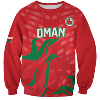 Red OMAN sweatshirt with green flag graphic and round crest patch on chest