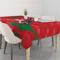Red cricket tablecloth with green flame design draped over table