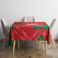 Red tablecloth with green flame print on dining table and chairs