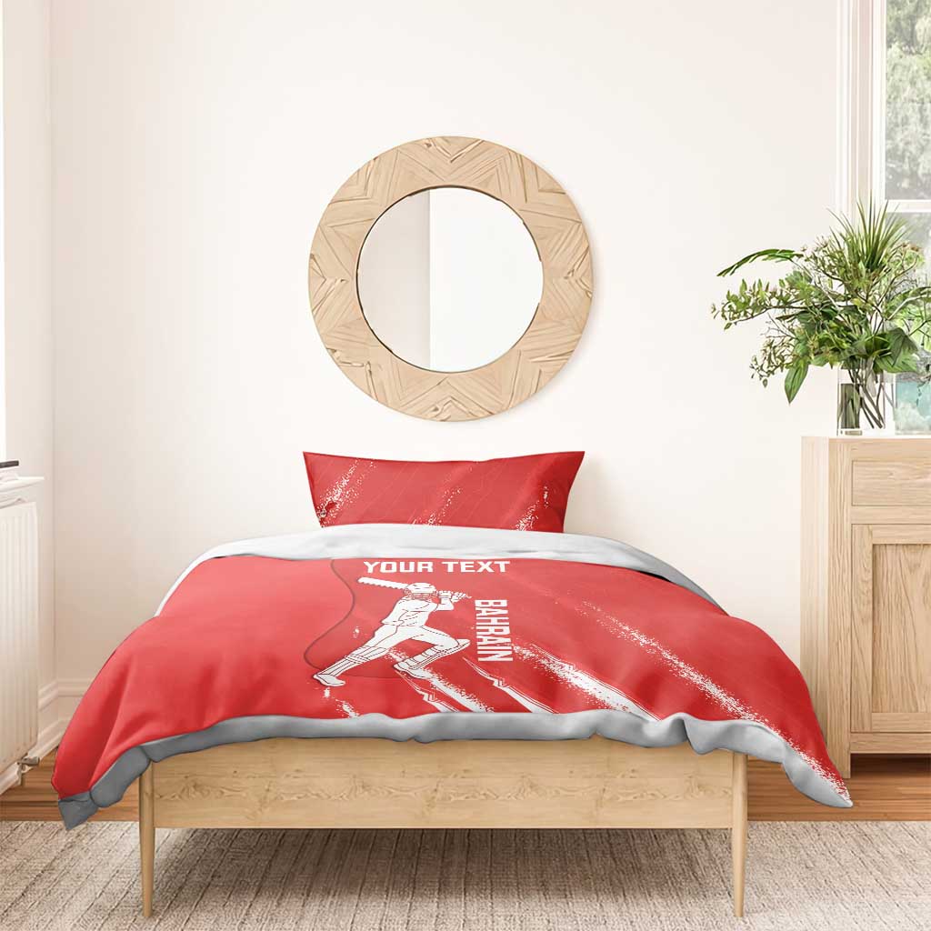 Red cricket duvet with player illustration and YOUR TEXT; two pillowcases on a bed frame.