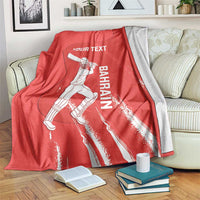 Red cricket blanket with Bahrain graphic and white Your Text print, draped on couch