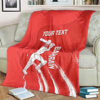 Red cricket blanket with Bahrain player graphic and Your Text print, folded on couch