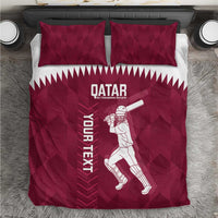 Maroon duvet cover and two pillowcases with Qatar text and cricket player graphic