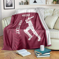 Maroon and white Qatar cricket blanket with player graphic and “YOUR NEXT” text