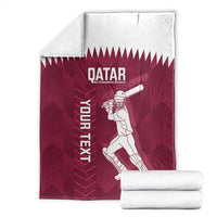 Maroon Qatar cricket blanket with player design, folded white base, and “YOUR NEXT” text