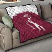 Qatar cricket quilt on sofa, maroon quilt with white Qatar crest and batsman graphic