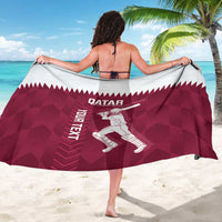 Maroon Qatar flag-style cricket sarong, back view with Qatar text and player illustration
