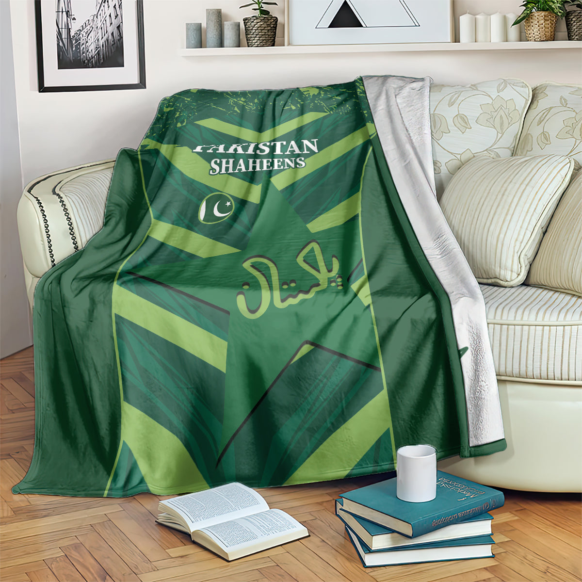 Green Pakistan Shaheens blanket with logo and lettering, draped over sofa