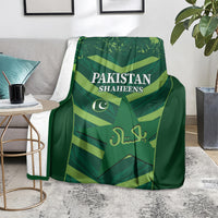 Green Pakistan Shaheens cricket blanket with team logo and lettering, draped on couch