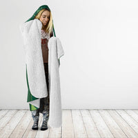 Green hooded blanket with gray sherpa lining over shoulders, casual cape fit