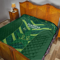 Green Pakistan Shaheens quilt on a bed with wooden headboard