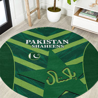 Green round carpet with Pakistan Shaheens text and crescent emblem, abstract waves