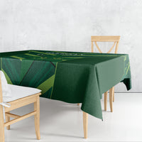 Green tablecloth draped over rectangular table with bold geometric stripe pattern