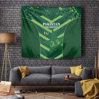 Green Pakistan Shaheens tapestry on a wall with shield emblem and crescent icon