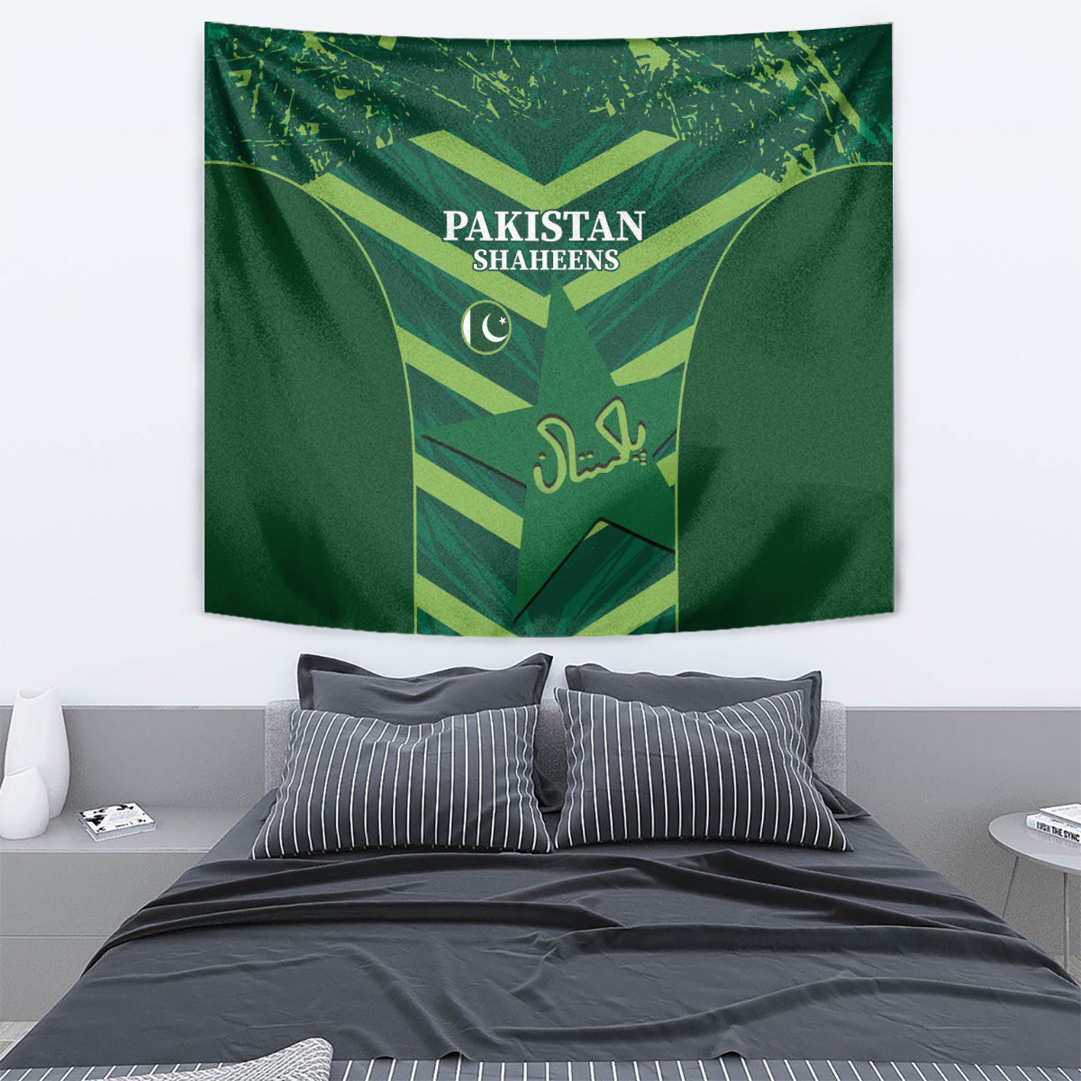 Green Pakistan Shaheens tapestry above a bed with shield emblem and crescent logo