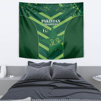 Green Pakistan Shaheens tapestry above a bed with shield emblem and crescent logo