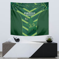 Green Pakistan Shaheens tapestry above a console with shield and crescent graphic