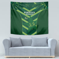 Green Pakistan Shaheens tapestry above a sofa with shield emblem and crescent icon
