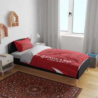 Red duvet cover and pillow set on bed; England Cricket text with crown and lion design