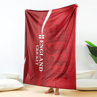 Red England cricket blanket with white vertical “ENGLAND CRICKET” and lion crown emblem, draped