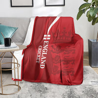 Red England cricket blanket with white “ENGLAND CRICKET” text and lion crown pattern, draped