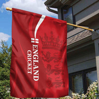 Red England cricket garden flag close-up on an outdoor pole with crest graphic