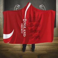 Red hooded blanket with white emblem and vertical text on the cape