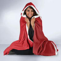 Red hooded blanket with sherpa-like white lining, worn and open in front