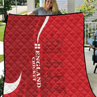 Red England cricket quilt close-up with white crescent and 'ENGLAND CRICKET' logo