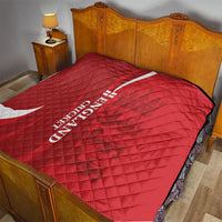 Red England cricket quilt spread on bed with white crescent and vertical text