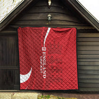 Red England cricket quilt hanging on a dark doorway with white crescent and text