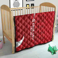 Red England cricket quilt on a crib with white crescent and 'ENGLAND CRICKET' text