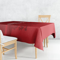 Red cricket-themed tablecloth covering table edge with darker patterned panel