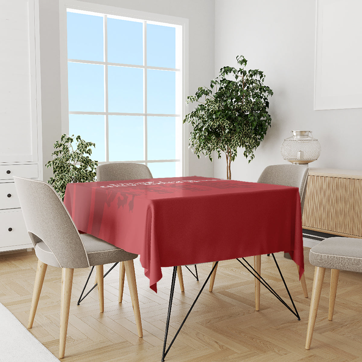 Red cricket-themed tablecloth on dining table with chairs and small centerpiece