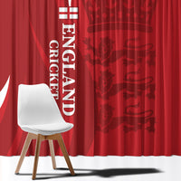 Red England cricket curtain close-up with vertical white text and crest, with patterned fabric
