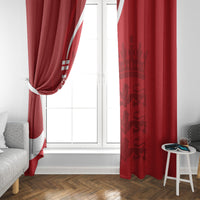 Red England cricket curtains at window with vertical white text and crest, gathered drape