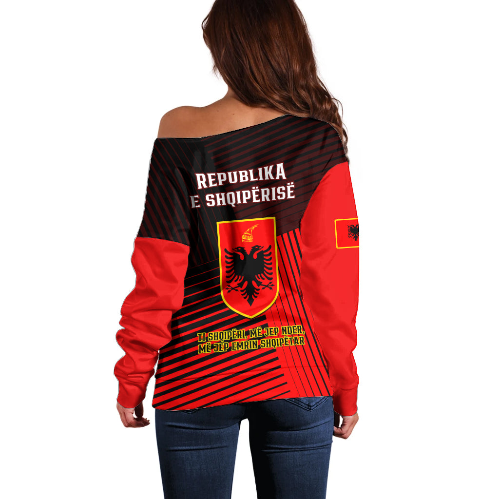 Off-shoulder red and black sweater with Albanian coat of arms on back