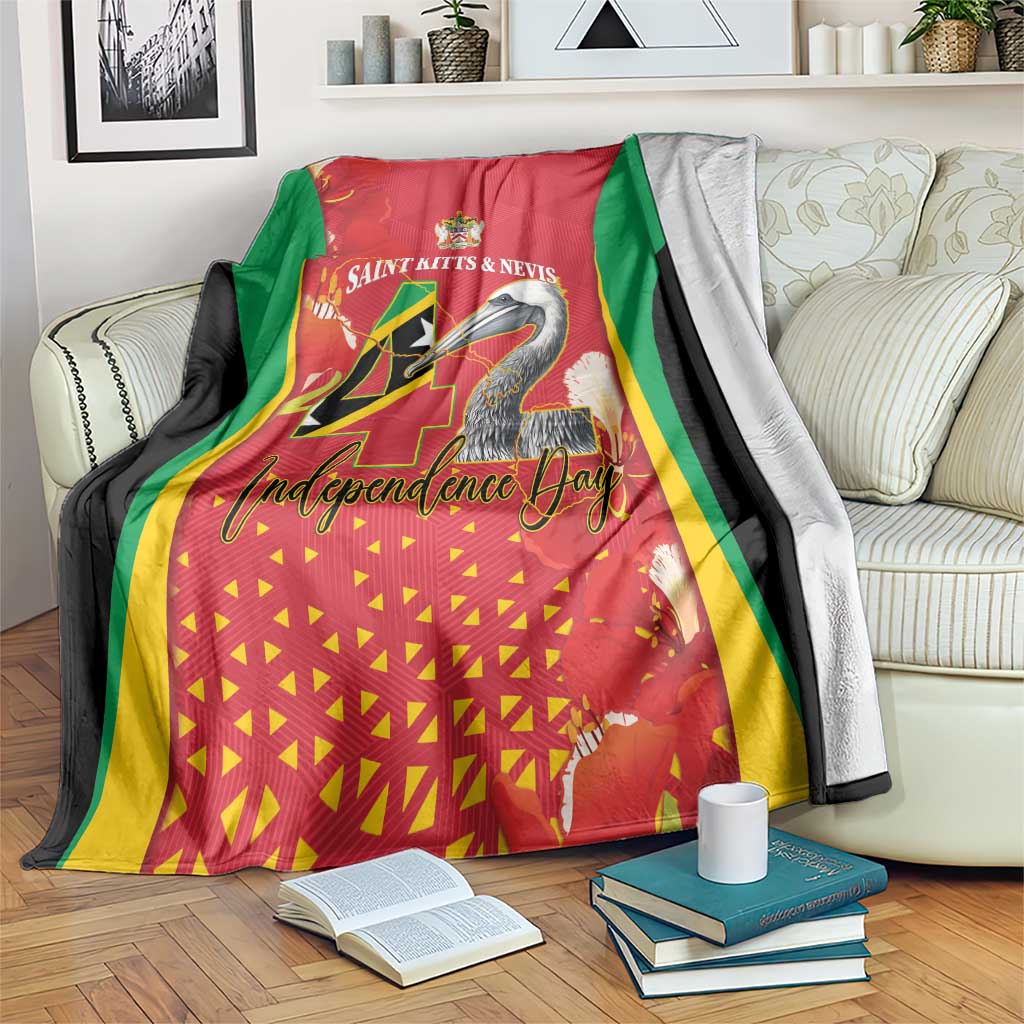 Red throw blanket with Saint Kitts & Nevis Independence Day pelican graphic and green trim