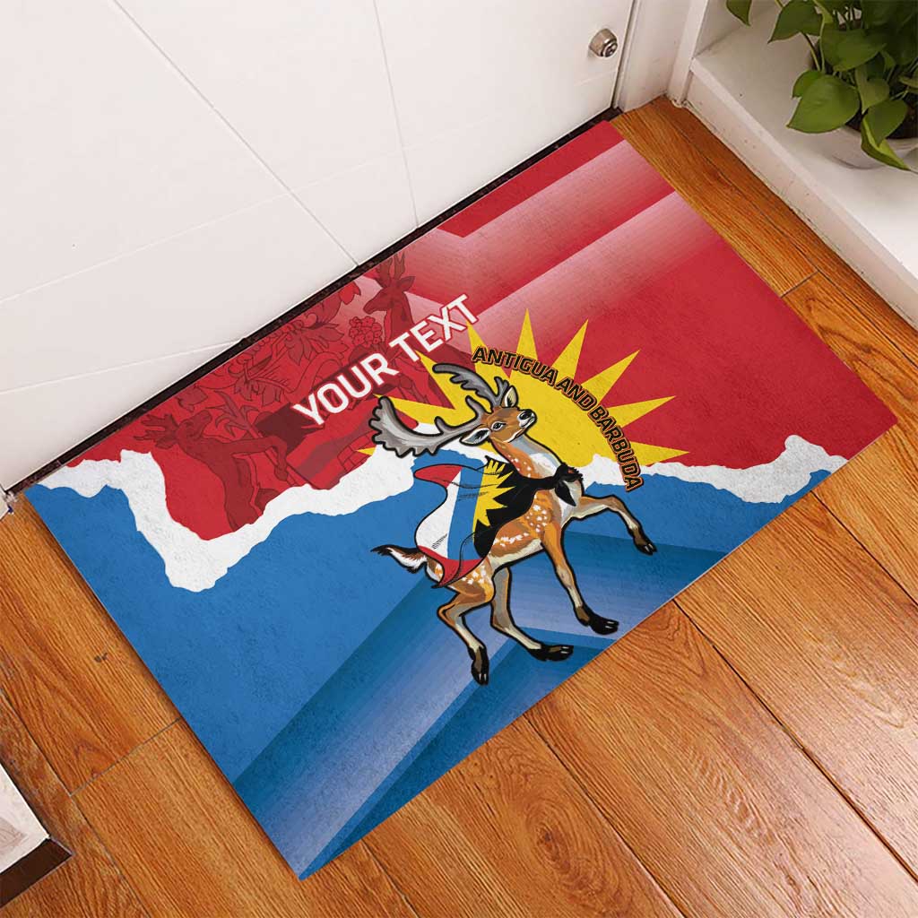 Red rubber doormat with Antigua flag and deer graphic, placed on wooden floor at entry
