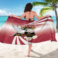 Red and white Latvia-themed 106th anniversary sarong with winged emblem and daisy print