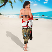 Yemen-themed sarong with coat-of-arms graphic and red trim, draped on back