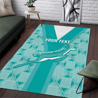 Teal area rug with geometric pattern, white stripe, and springbok emblem, 'YOUR TEXT'