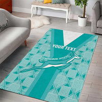 Teal geometric area rug with white center stripe and springbok graphic, 'YOUR TEXT'