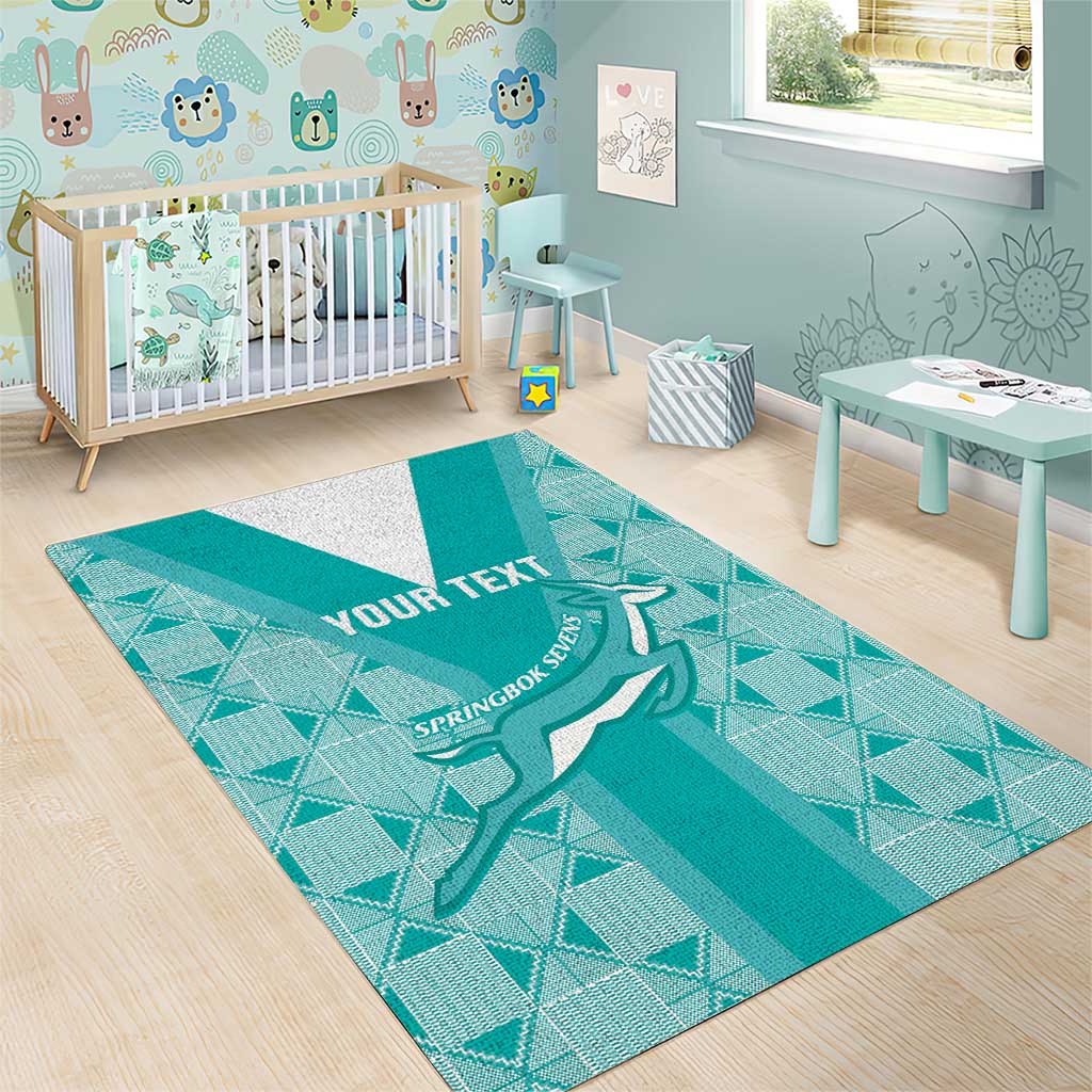 Teal area rug in nursery with geometric pattern, white stripe, springbok emblem, 'YOUR TEXT'