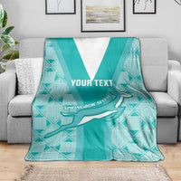 Teal custom rugby blanket draped over sofa with white V stripe, Springbok graphic, "YOUR TEXT"