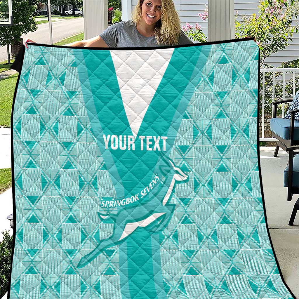 Teal rugby quilt with white triangle, diamond pattern, “YOUR TEXT” and player graphic