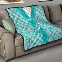 Teal rugby quilt draped on sofa with white triangle, diamond pattern, and “YOUR TEXT”