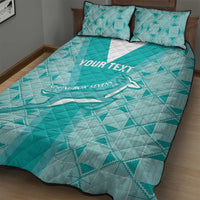 Teal quilt bed set with two pillows, diagonal geometric pattern and Springbok Sevens graphic