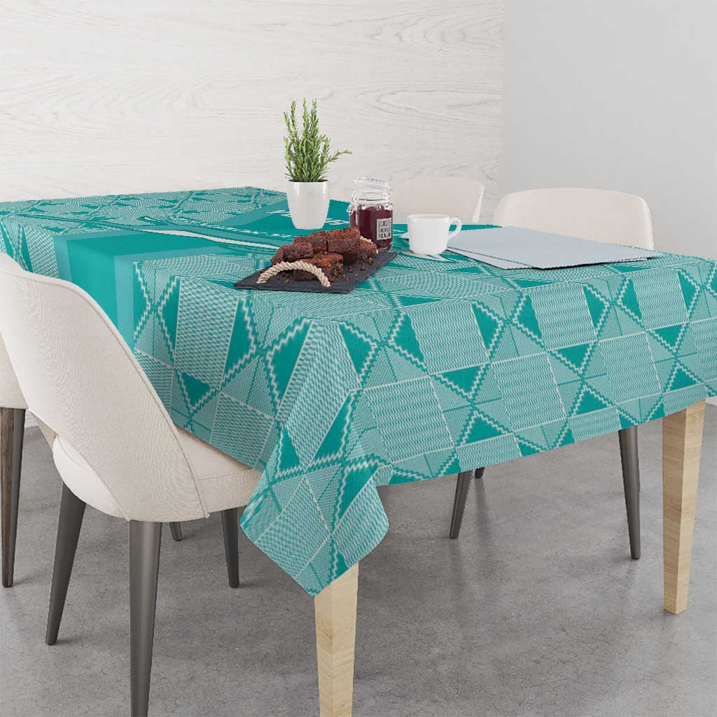 Teal geometric diamond tablecloth on dining table with cutlery and plants