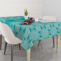 Teal geometric diamond tablecloth on dining table with cutlery and plants
